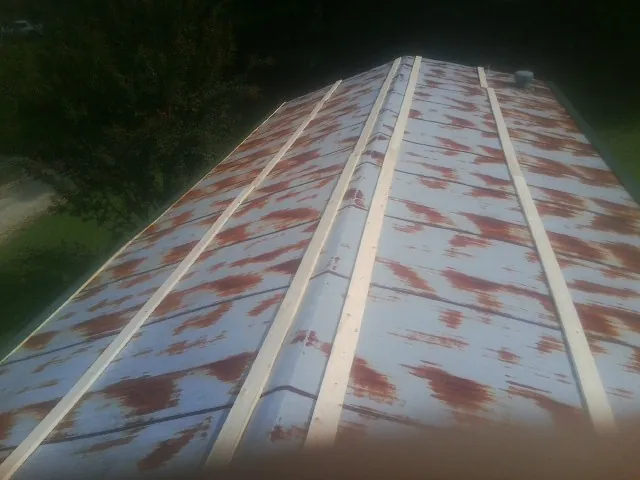 Rusted metal roof panels with new wood purlins before replacement — Storm Damage Roof Repair in Buffalo Grove by Roofing Brothers