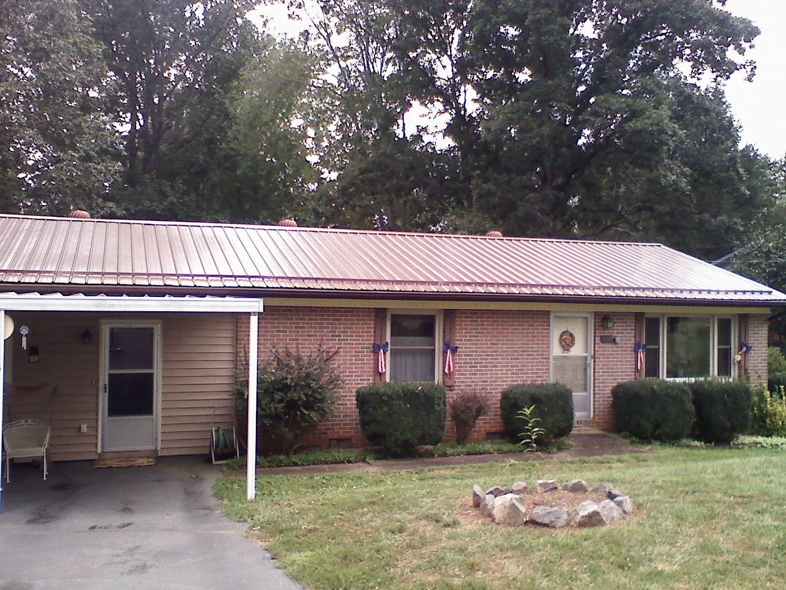 Bronze metal roof and carport on a brick ranch home — Roof Repair work by our crew in Buffalo Grove